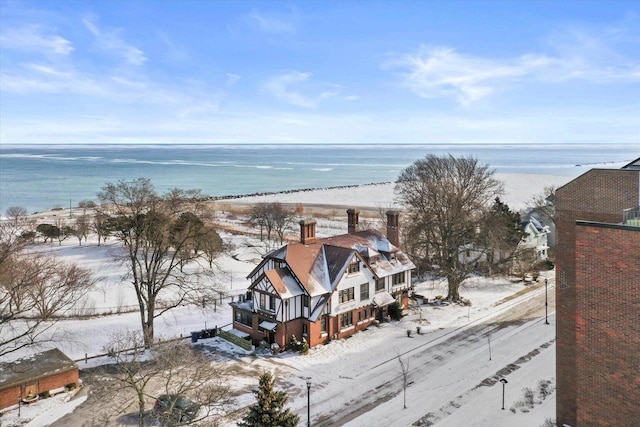 drone / aerial view with a water view and a beach view