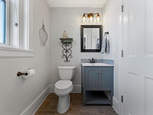 bathroom with decorative backsplash, vanity, wood-type flooring, and toilet