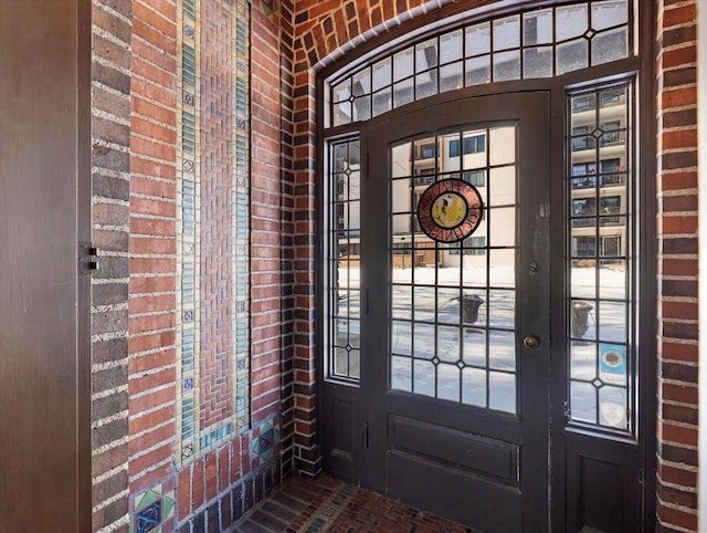 doorway to outside featuring french doors and brick wall