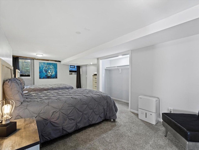 carpeted bedroom featuring a walk in closet and a closet