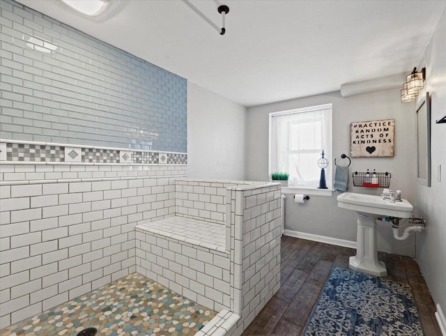 bathroom featuring a tile shower and hardwood / wood-style floors