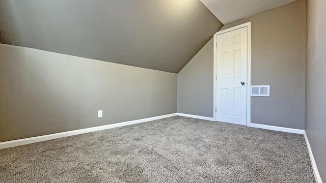 additional living space with carpet flooring and lofted ceiling