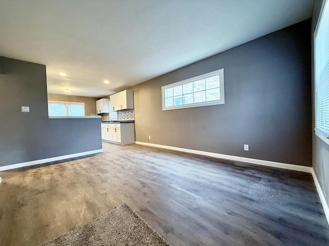 unfurnished living room featuring hardwood / wood-style flooring