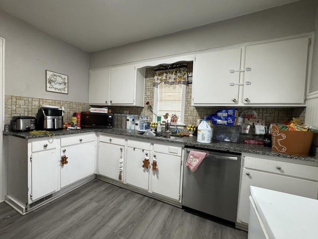 kitchen with sink, stainless steel dishwasher, backsplash, white cabinets, and hardwood / wood-style flooring