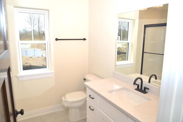 bathroom with tile patterned floors, vanity, and a wealth of natural light