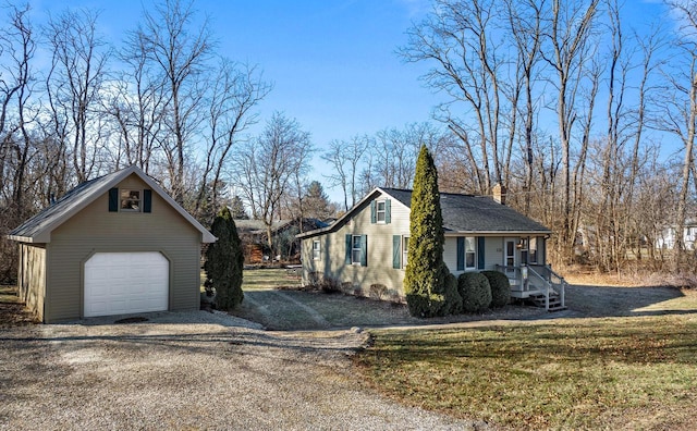 view of side of home featuring a lawn, covered porch, an outdoor structure, and a garage