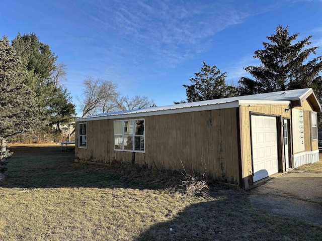 view of side of home with an outdoor structure and a garage