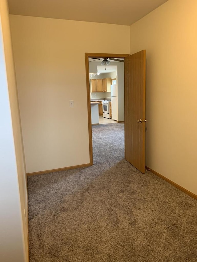 empty room with carpet and ceiling fan