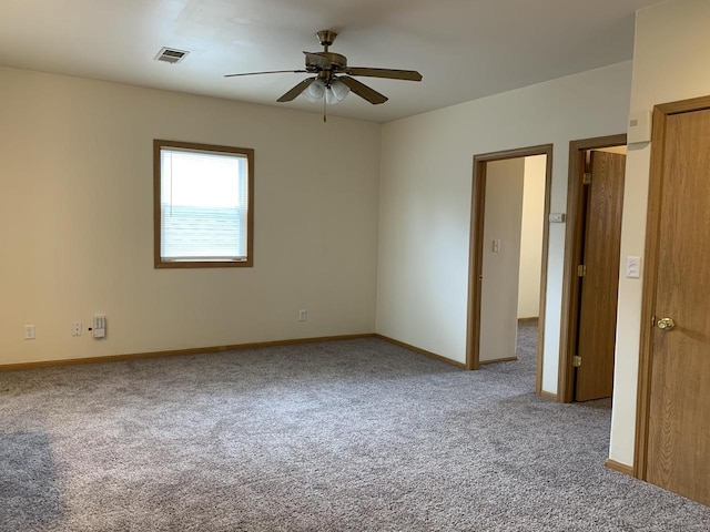 unfurnished room featuring ceiling fan and carpet