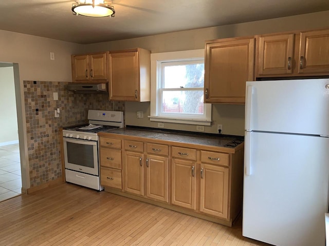 kitchen with decorative backsplash and white appliances