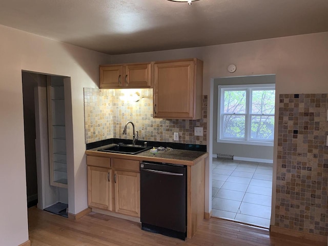 kitchen with decorative backsplash, light brown cabinetry, light wood-type flooring, sink, and black dishwasher