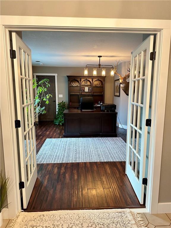 interior space with dark hardwood / wood-style flooring and french doors