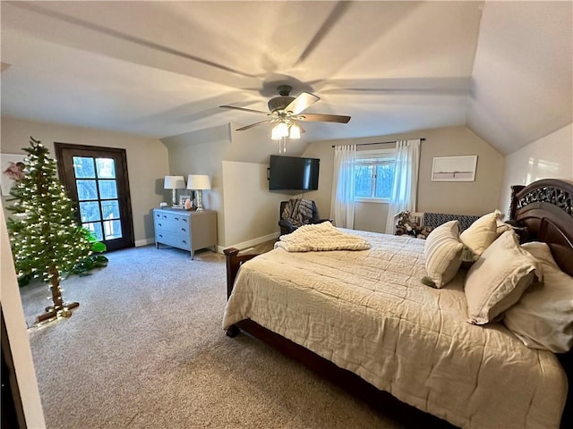 carpeted bedroom with ceiling fan and vaulted ceiling