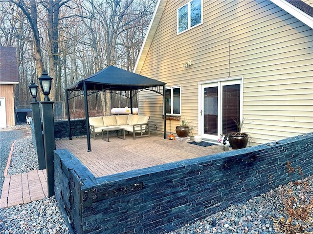 exterior space featuring a gazebo, a patio area, and an outdoor hangout area