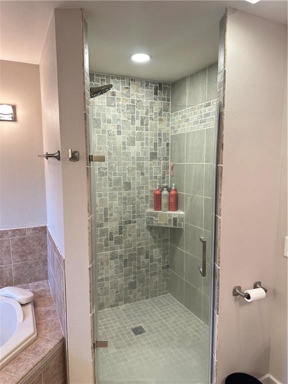 bathroom with plus walk in shower and tile walls