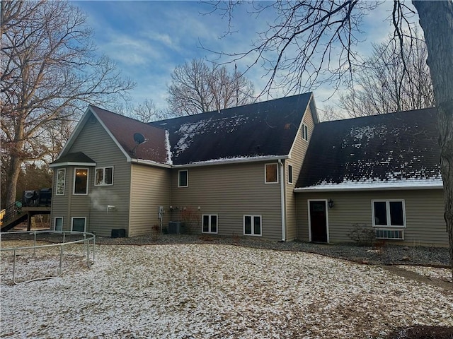 back of property featuring a trampoline