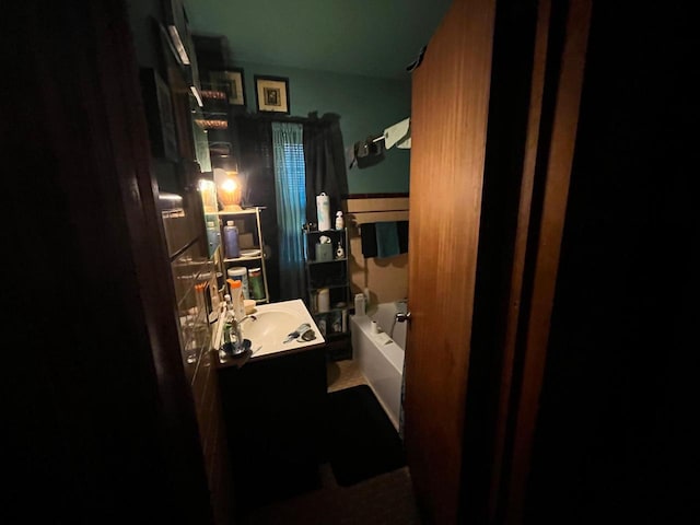 bathroom with a tub to relax in and vanity