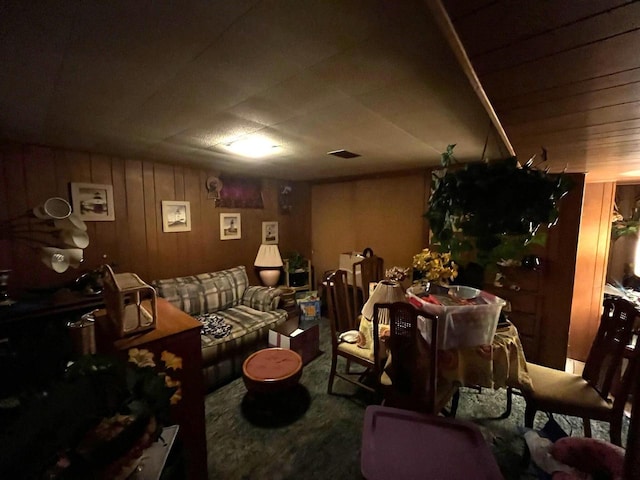 interior space with carpet flooring and wooden walls