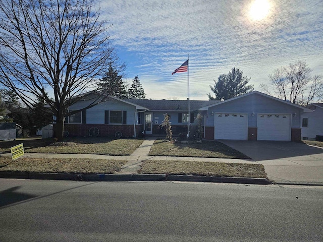 ranch-style home with a garage and a front yard