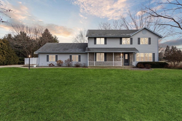 view of front of house featuring a lawn and a porch