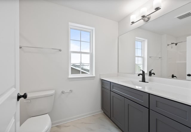 bathroom with vanity, toilet, and walk in shower