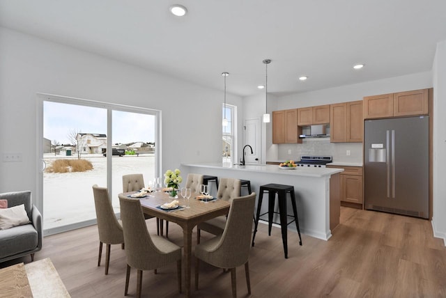 dining area featuring hardwood / wood-style flooring and sink