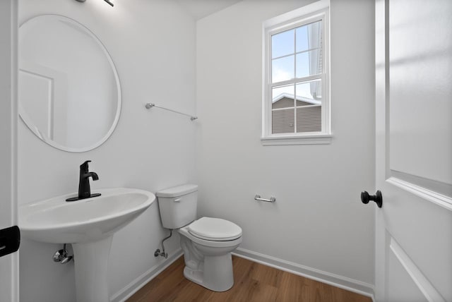 bathroom featuring hardwood / wood-style floors and toilet