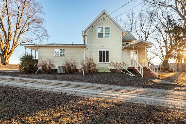 rear view of property featuring central AC unit