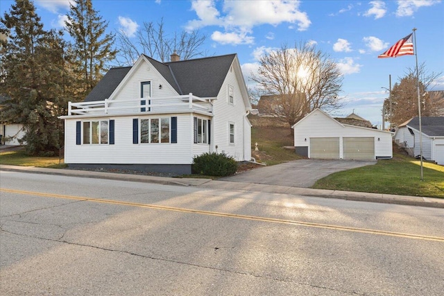 view of side of home with an outbuilding, a yard, and a garage