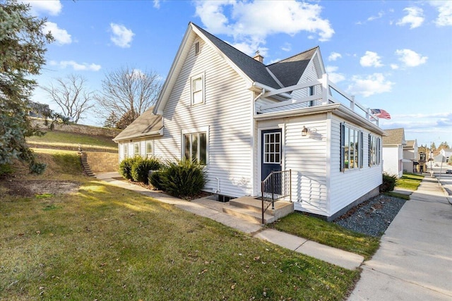 view of side of property featuring a yard