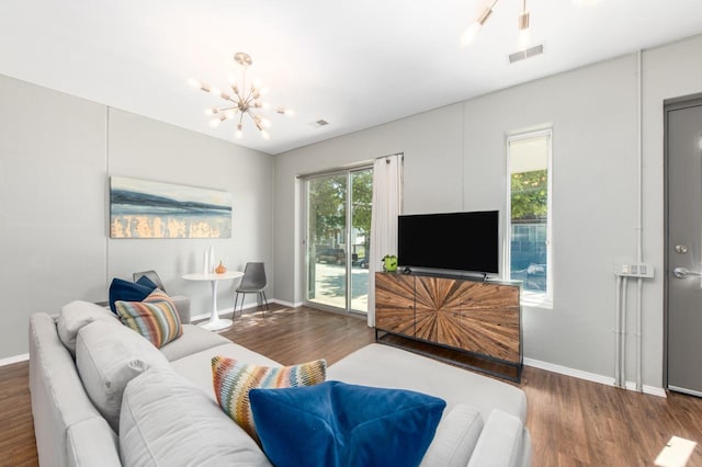 living room featuring a chandelier and dark hardwood / wood-style flooring