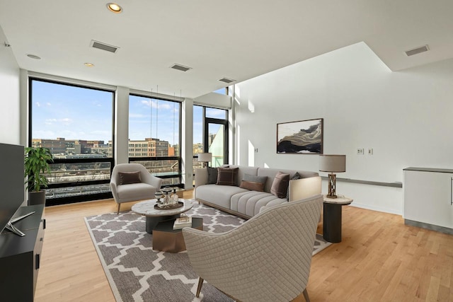 311 E Erie St Unit 411, Milwaukee, WI 53202 - living room featuring floor to ceiling windows, light wood finished floors, and a city view