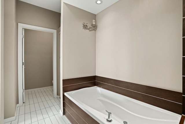 bathroom with toilet, a relaxing tiled tub, and tile patterned floors