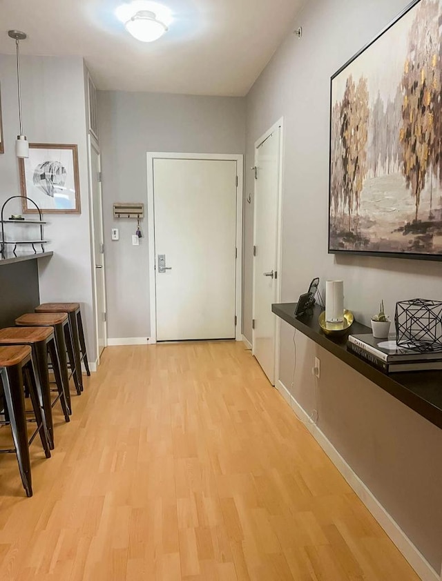 hall with light hardwood / wood-style floors