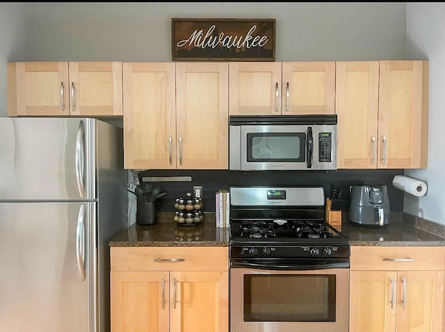 kitchen with appliances with stainless steel finishes and light brown cabinets