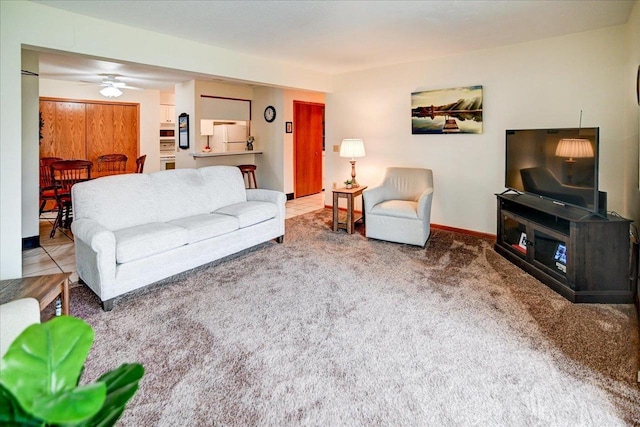 living room featuring ceiling fan and carpet