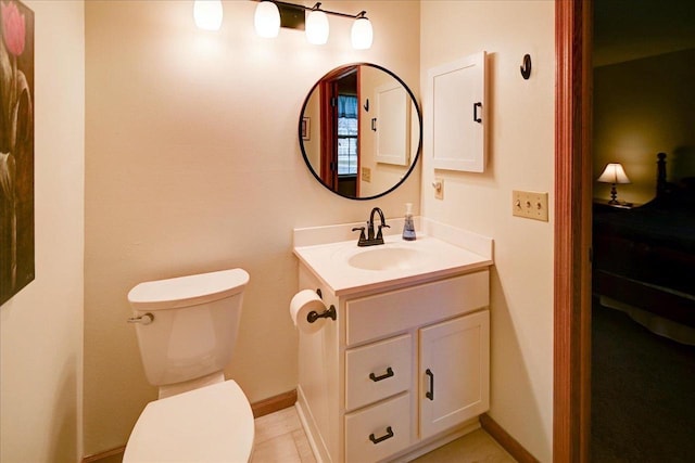 bathroom featuring tile patterned flooring, vanity, and toilet