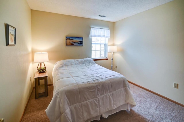 carpeted bedroom featuring a textured ceiling