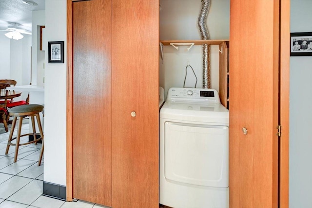 washroom featuring ceiling fan, light tile patterned floors, and washer and dryer