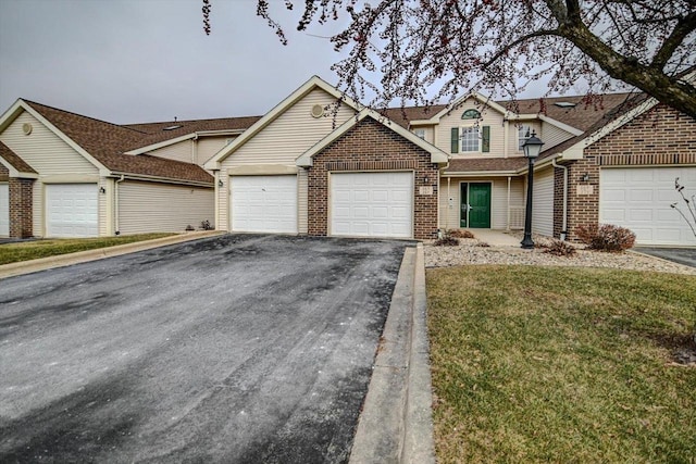 view of front of property with a garage and a front lawn