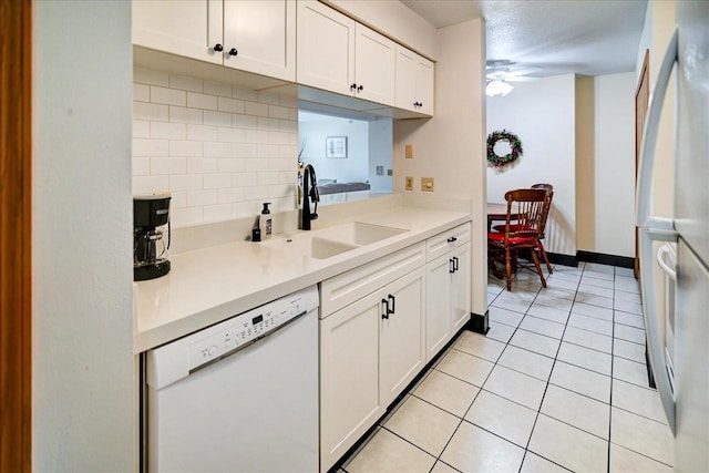 kitchen with tasteful backsplash, white appliances, ceiling fan, sink, and white cabinets