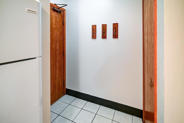 hall featuring light tile patterned floors