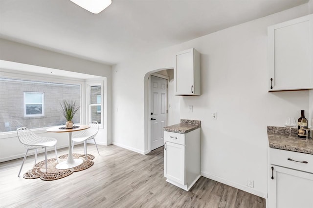 kitchen featuring white cabinetry and light hardwood / wood-style floors