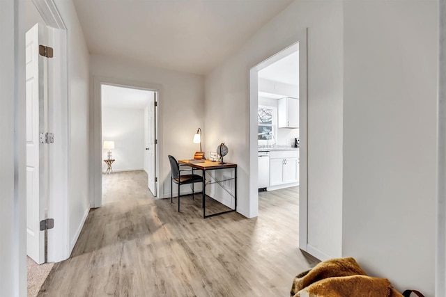 hallway with light hardwood / wood-style flooring