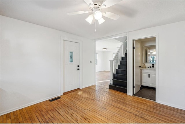 foyer with ceiling fan and hardwood / wood-style flooring