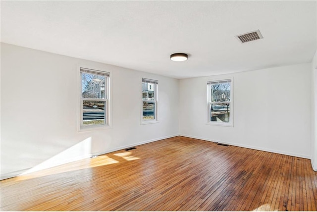 unfurnished room with wood-type flooring