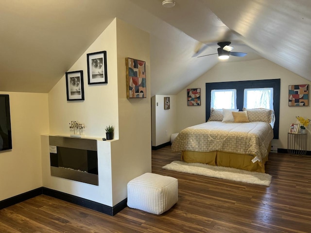 bedroom featuring ceiling fan, dark hardwood / wood-style flooring, and vaulted ceiling