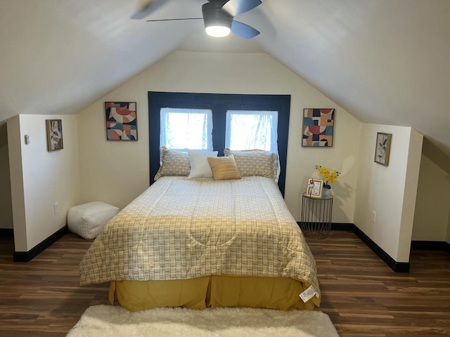 bedroom featuring dark hardwood / wood-style flooring, vaulted ceiling, and ceiling fan