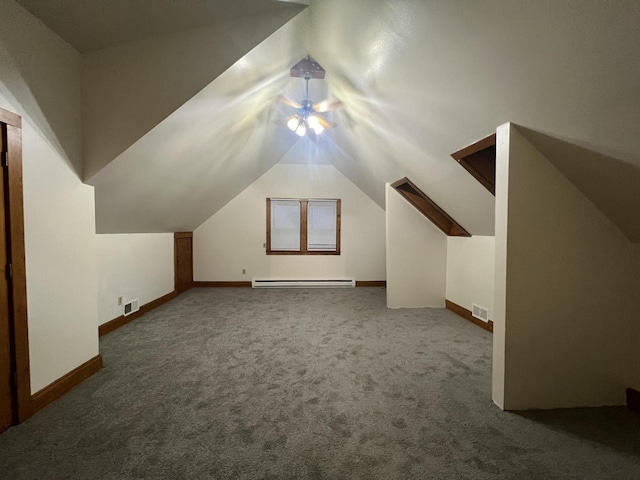 bonus room featuring dark colored carpet, baseboard heating, and lofted ceiling