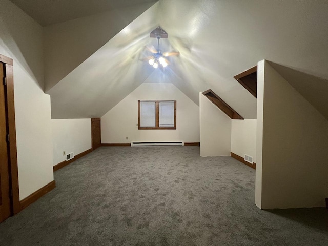 bonus room with dark colored carpet, vaulted ceiling, baseboard heating, and ceiling fan